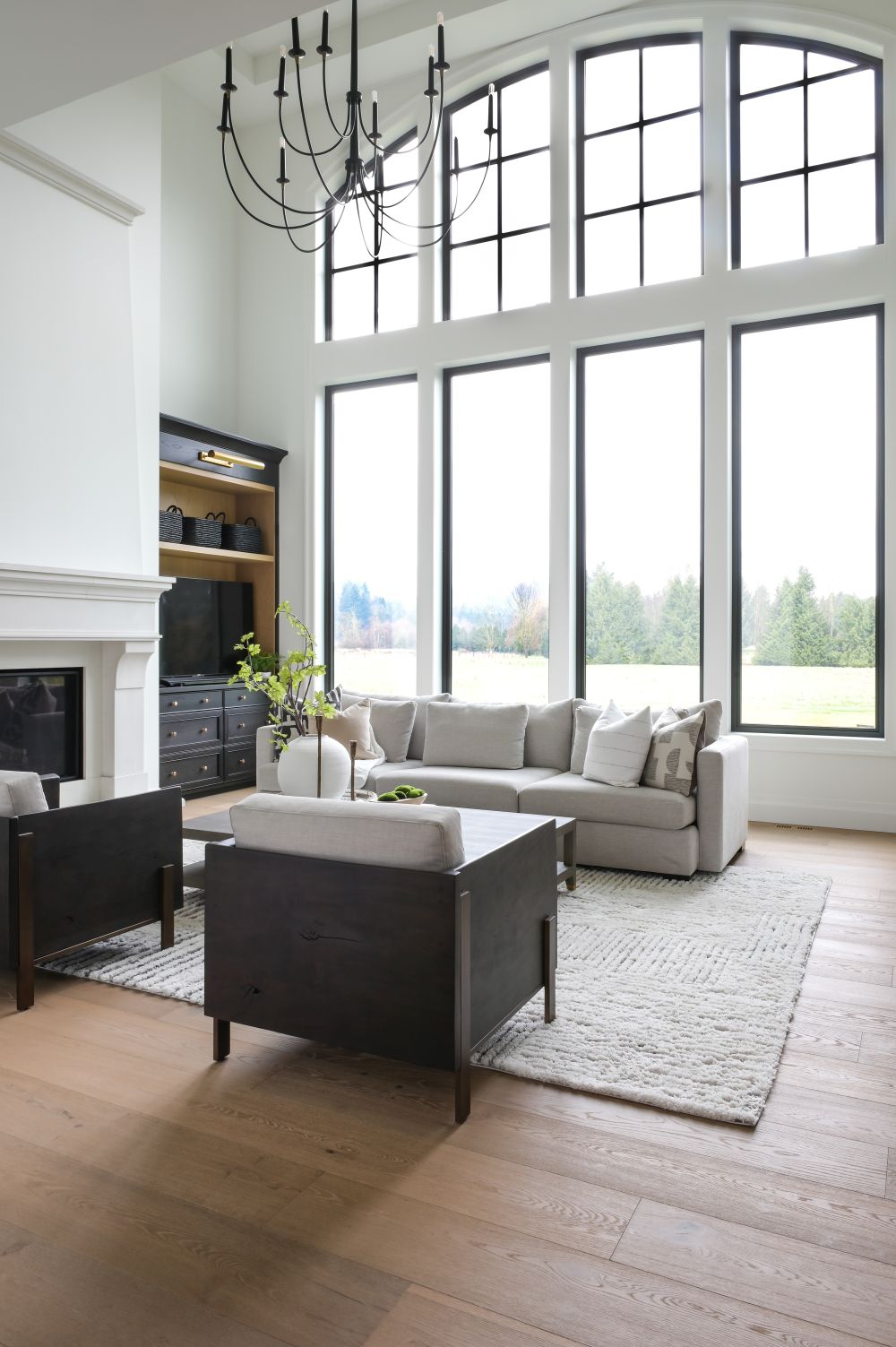 Bright living room in Langley with tall windows, light walls and a fireplace