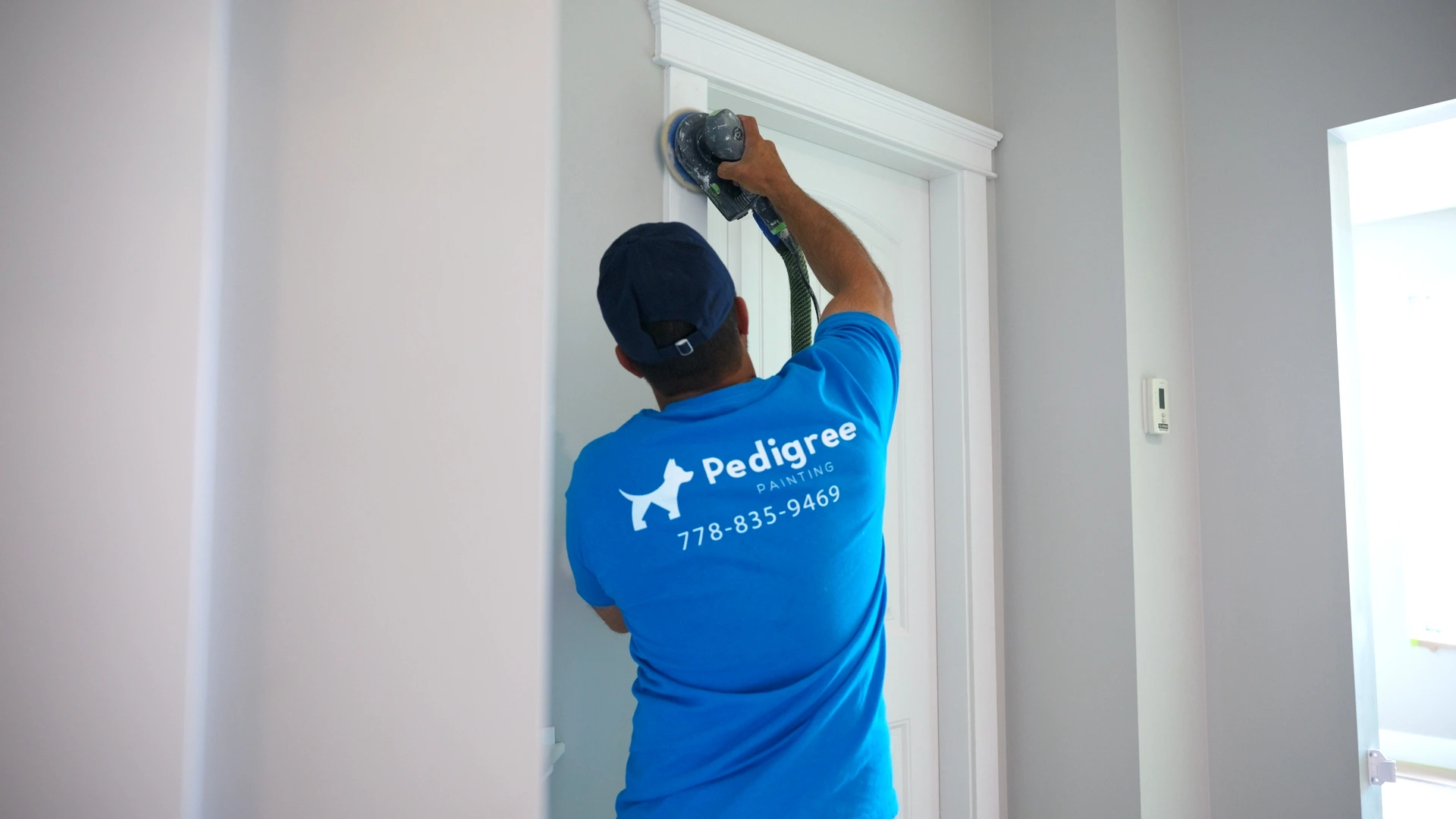 Painter carefully preparing an interior door surface