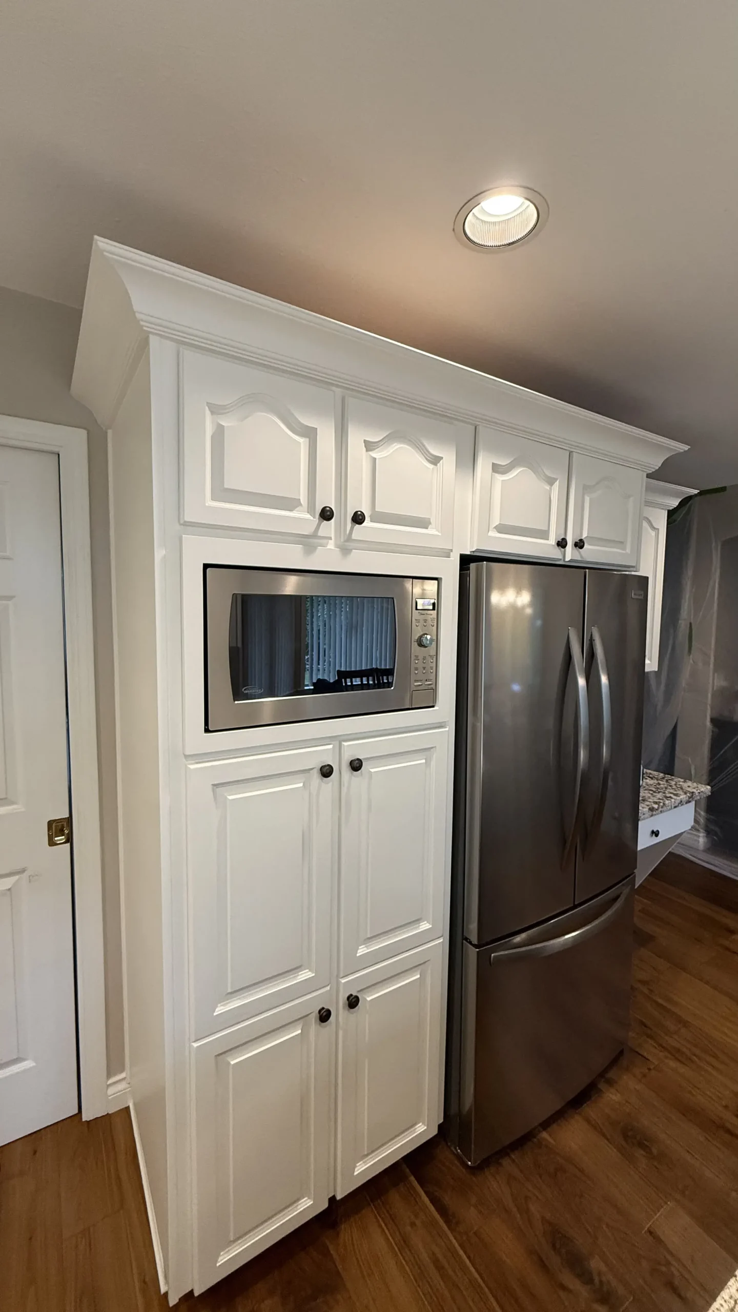 Refinished kitchen cabinets featuring a smooth professionally sprayed finish